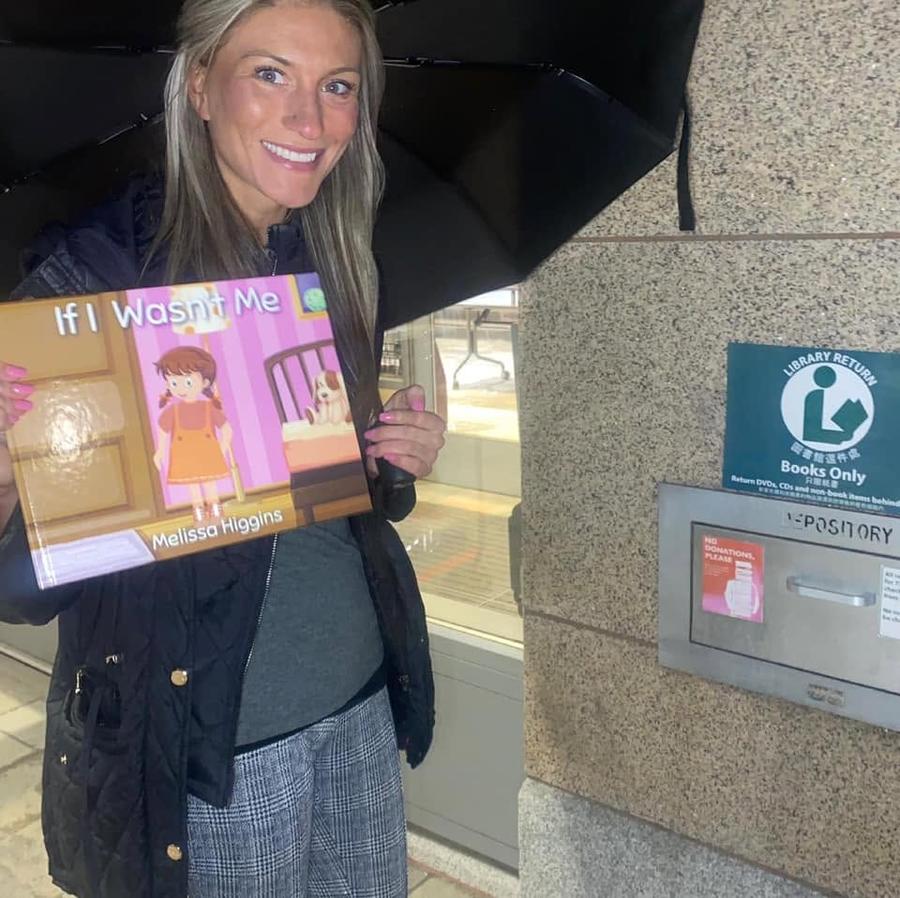 Lindsay holding her published children's book, If I Wasn't Me